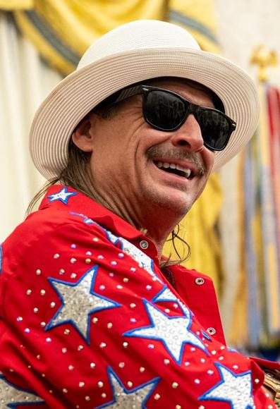 President Donald Trump signs an Executive Order alongside Kid Rock in the Oval Office, Monday, March 31, 2025. (Official White House Photo by Molly Riley)